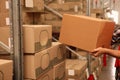 Worker stacking boxes in warehouse, closeup. Wholesaling