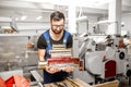 Worker with stamping foil rolls at the manufacturing Royalty Free Stock Photo