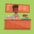 Worker standing behind the counter at the bakery. Royalty Free Stock Photo