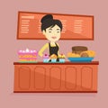 Worker standing behind the counter at the bakery. Royalty Free Stock Photo