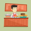 Worker standing behind the counter at the bakery. Royalty Free Stock Photo