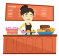 Worker standing behind the counter at the bakery. Royalty Free Stock Photo