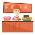 Worker standing behind the counter at the bakery. Royalty Free Stock Photo