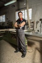 Worker looking at camera in a factory