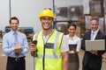 Worker standing with scanner in front of his colleagues Royalty Free Stock Photo