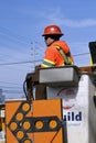 Worker stands in aerial lift bucket