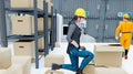 Worker supervising products and shipping goods in a logistics, distribution and storage center and female worker Royalty Free Stock Photo