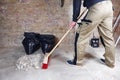 Worker sweeping rubble and dust with red broom Royalty Free Stock Photo