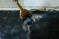 Worker sweeps construction debris with a broom. Royalty Free Stock Photo