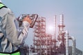 Worker with tablet in hand in oil refinery plant or power plant