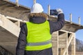 Worker take pictures on tablet near the unfinished bridge