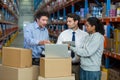 Worker team looking a laptop put on a cardboard box Royalty Free Stock Photo