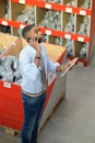 Worker on telephone in plumbing supplies shop Royalty Free Stock Photo