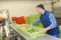 Worker tending conveyor