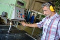 Worker tending to machine