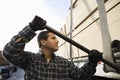 Worker Tightening Belt Of A Trailer With Metal Rod