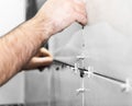 Worker tiler puts ceramic tiles