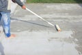 Worker to skim coat surface of concrete pavement floor or slab