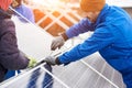 Worker with tools maintaining photovoltaic panels. Engineers installing solar panels Royalty Free Stock Photo