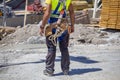 Worker with tools in toolbelt and construction tools Royalty Free Stock Photo