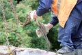 worker touches the crane hooks to the loops in the concrete slab during repair work.