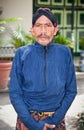 Worker in traditional Javanese costume posing in Kraton Sultan P Royalty Free Stock Photo