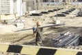 A worker transfers elements for the installation of the formwork at the construction site. Monolithic concrete formwork during the Royalty Free Stock Photo