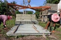 Worker transporting concrete slabs with truck crane