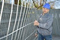 Worker transporting metal fence