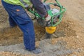 Worker with trench rammer