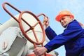 Worker turns big gas valve Royalty Free Stock Photo