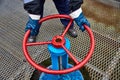 Worker turns the valve and closes the oil supply. Hands and stop valves close up