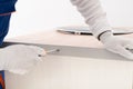 A worker twists an aluminum corner with a screwdriver to the kitchen countertop