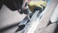 Worker twists the screw into the metal