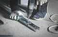 Worker twists the screw into the metal