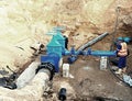 Worker underground for reconstrucion of drink water system. Technical expert at gate valve Royalty Free Stock Photo