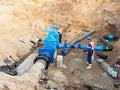 Worker underground for reconstrucion of drink water system. Technical expert at gate valve Royalty Free Stock Photo