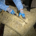Worker in uniform cutting  mineral wool panels Royalty Free Stock Photo