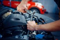 Worker disassembles vehicle engine, car service Royalty Free Stock Photo