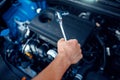 Worker disassembles vehicle engine, car service Royalty Free Stock Photo