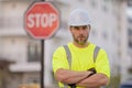 Worker in uniform gesturing stop. Serious engineer with stop road sign. Builder with stop gesture, no hand, dangerous on