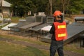 The worker in uniform and helmet checks concentrating Solar Power with Flat Plat collector and Evacuum Tube Collector.