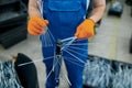 Worker installs new bicycle spokes on factory Royalty Free Stock Photo