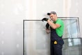 Worker in uniform preparing double glazing window for installation indoors Royalty Free Stock Photo