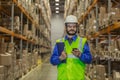 Worker in uniform using mobile phone at warehouse Royalty Free Stock Photo