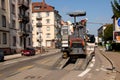 A worker unloading an Asphalt Milling Machine from a trunk