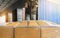 Worker unloading cargo shipment goods. package box, his using hand pallet jack load into a truck, Road freight transpor