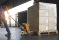 Worker Unloading Package Box Out of The Inside Cargo Container. Delivery Service. Shipping Warehouse Logistics and Transport Royalty Free Stock Photo