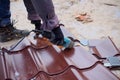 Worker use grinding machine for cutting of metal roofing sheet Royalty Free Stock Photo