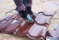 Worker use grinding machine for cutting of metal roofing sheet Royalty Free Stock Photo